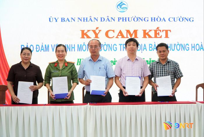 Đại diện các cơ quan, đơn vị của phường Hòa Cường ký cam kết bảo đảm vệ sinh môi trường. Ảnh: VINH ANH