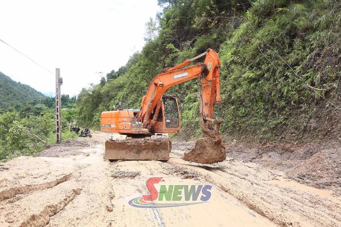Máy xúc được huy động để san gạt đất đá thông tuyến đường.