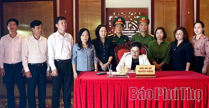 Đồng chí Phó Bí thư Tỉnh ủy, Chủ tịch Ủy ban MTTQ tỉnh Bùi Thị Minh ghi lưu bút tại Nhà tưởng niệm, Nghĩa trang liệt sĩ quốc gia Vị Xuyên. (Ảnh: Báo Phú Thọ)