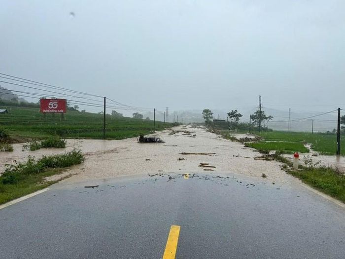 Ngày 17/7, tại Km354 quốc lộ 32, đoạn qua bản Che Bó, Đội 11, xã Mường Than, tỉnh Lai Châu nước lũ dâng cao cuốn theo bùn đất, cành cây tràn kín mặt đường - Ảnh: Báo XD