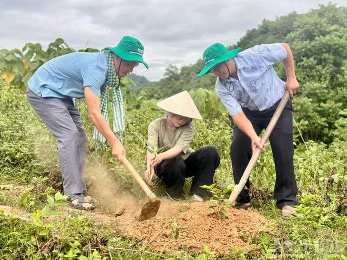 Cán bộ địa phương và đại diện doanh nghiệp cùng trồng cây giống.