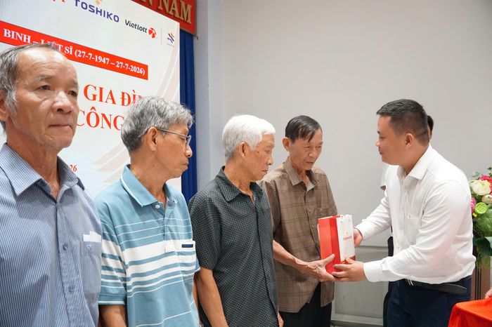 Giám đốc Kinh doanh Công ty TOSHIKO Lê Trung Hiếu tặng máy đo huyết áp cho người có công. Ảnh: VIỆT NGA