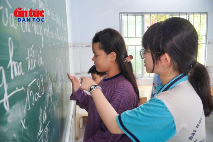 Các tình nguyện viên hỗ trợ học sinh hoàn thành bài tập và củng cố kiến thức trước năm học mới.
