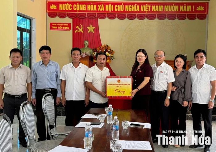 Phó trưởng Đoàn ĐBQH tỉnh Lương Thị Hoa trao quà cho Chi bộ thôn Tiến Hưng, xã Luận Thành.