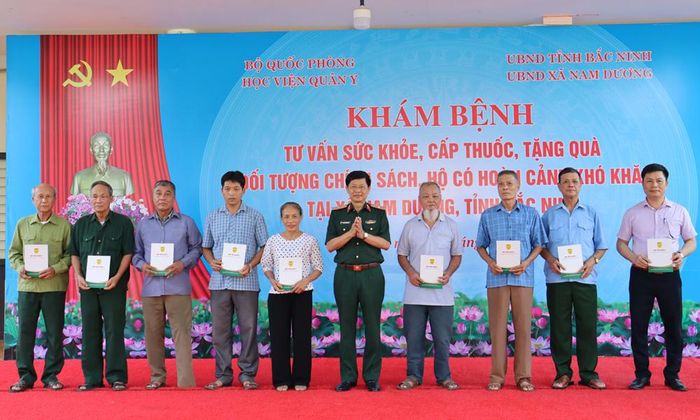  Thiếu tướng Nguyễn Văn Nam tặng quà các gia đình chính sách xã Nam Dương. 