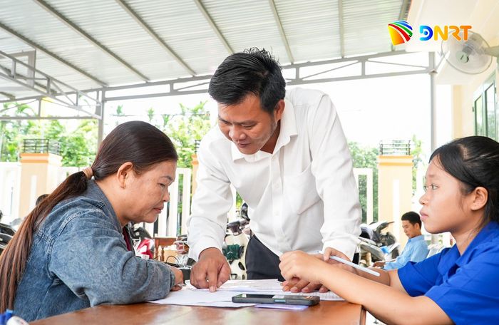Trung tâm Phục vụ hành chính công xã Thạnh Bình hướng dẫn người dân thực hiện các thủ tục hành chính. Ảnh: HỒ QUÂN