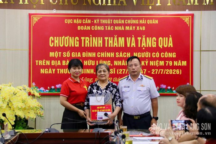 Lãnh đạo Nhà máy X48 Cục Hậu cần - Kỹ thuật Hải quân và cô giáo Bùi Thị Hồng tặng quà cho gia đình Anh hùng Trần Minh Nghĩa, xã Hữu Lũng
