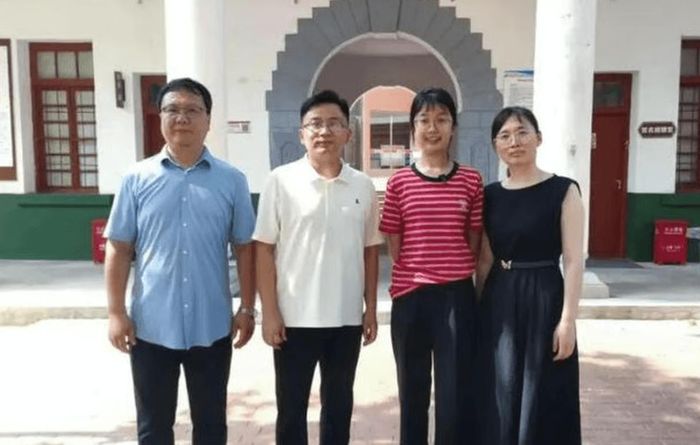 Em Xu chụp ảnh cùng các giáo viên trung học của mình. Giáo viên chủ nhiệm khen ngợi em là người rất kiên trì và có tư duy độc lập. Ảnh: 163.com