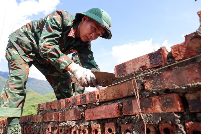 Giữa nền đất còn ngổn ngang sau lũ, các cán bộ, chiến sĩ Trung đoàn 880, Bộ Chỉ huy Quân sự tỉnh Lai Châu chia nhau từng phần việc, chạy đua với thời gian để dựng nên những mái nhà đầu tiên cho người dân bản Chít.