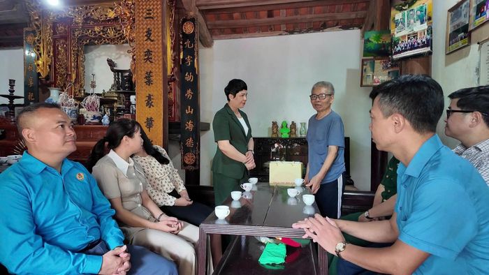 Phó Bí thư Thường trực Đảng ủy xã An Khánh Trương Thị Dung thăm hỏi, tặng quà ông Nguyễn Danh Kho, thôn An Thọ. Ảnh: AK