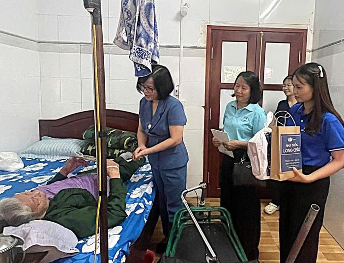 TS.Nguyễn Khánh Phương tặng quà các thương, bệnh binh nặng tại buồng bệnh (Ảnh: Viện Chiến lược và Chính sách Y tế).