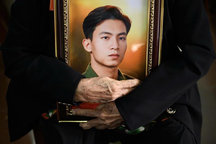 Bà Ân ôm chặt di ảnh của chồng. Ảnh: Hoài Bảo.
