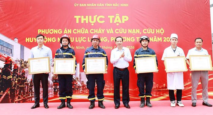  Đồng chí Nghiêm Xuân Hưởng trao Bằng khen của Chủ tịch UBND tỉnh cho các cá nhân có đóng góp cho công tác thực tập phương án chữa cháy. 