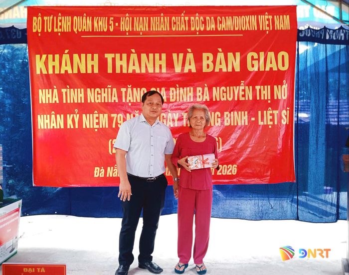 Ông Nguyễn Phước Sơn, Bí thư Đảng ủy, Chủ tịch HĐND xã Quế Sơn Trung, đại diện lãnh đạo xã Quế Sơn Trung tặng quà cho bà Nguyễn Thị Nở. Ảnh: DUY THÁI