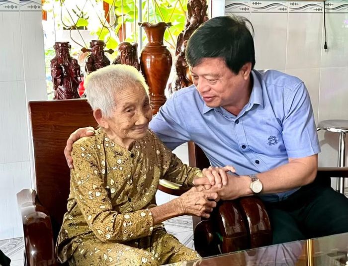 Phó Chủ tịch Thường trực UBND tỉnh Nguyễn Tuấn Thanh hỏi thăm sức khỏe Mẹ Việt Nam anh hùng Nguyễn Thị Bảy (xã An Lương). Ảnh: Nhật Trường