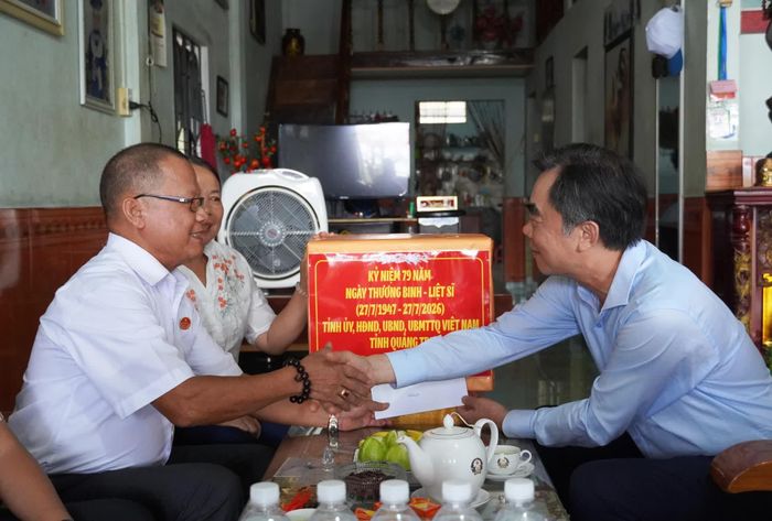 Đồng chí Nguyễn Lương Bình, Trưởng ban Tổ chức Tỉnh ủy tặng quà, chúc sức khỏe thương binh Lê Quang Lộc - Ảnh: X.P