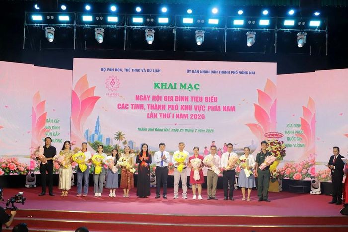 Ông Nguyễn Hữu Ngọc, Phó Chánh Văn phòng Bộ VHTTDL và bà Lê Thị Ngọc Loan, Giám đốc Sở VHTTDL TP Đồng Nai trao hoa cho các gia đình tiêu biểu