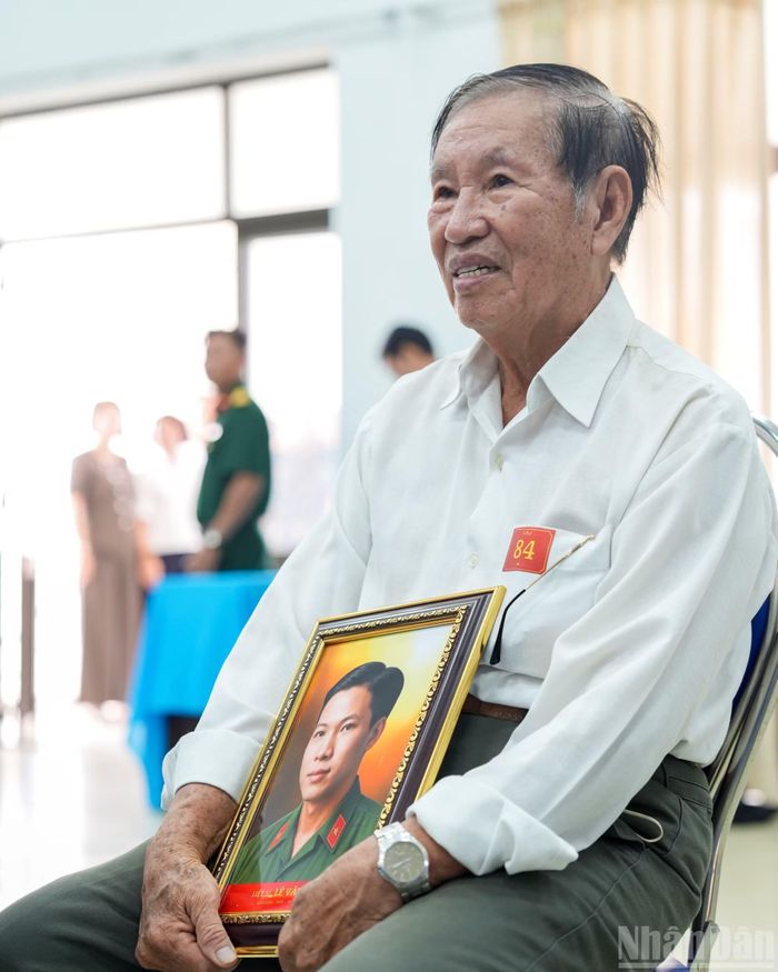 Ông Hồ Văn Đằng cầm trên tay di ảnh anh trai là liệt sĩ Lê Văn Tới, hy sinh trong Chiến dịch Mậu Thân 1968. Sau 58 năm, gia đình mới có di ảnh để thờ cúng. Trước đó, kỷ vật duy nhất của liệt sĩ là Bằng Tổ quốc ghi công. Bức ảnh được phục dựng từ những dữ liệu ít ỏi, gồm một tấm ảnh chụp chung với đồng đội và một phần góc mặt của người thân trong gia đình.