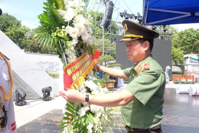 Thiếu tướng Nguyễn Hữu Hợp sửa lại vòng hoa trước khi dâng hương.