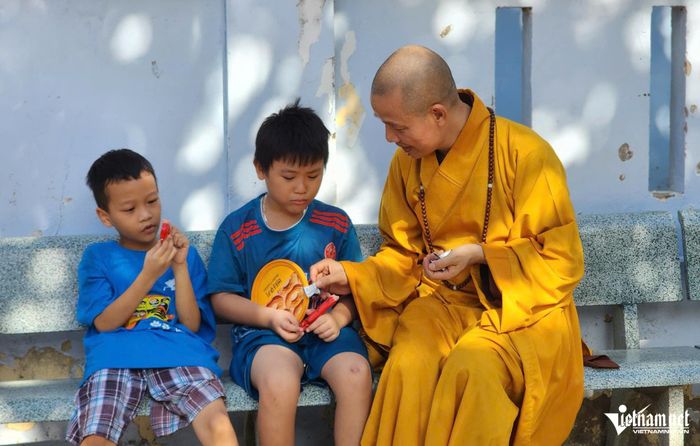 Thượng tọa Thích Minh Quang cùng các em nhỏ trên đảo Sinh Tồn. 