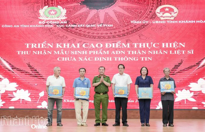 Đại tá Trần Minh Trúc - Phó Giám đốc Công an tỉnh trao quà cho thân nhân liệt sĩ.