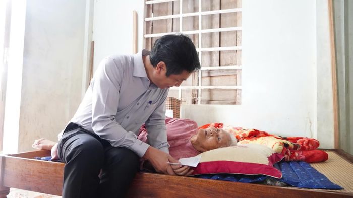 Đồng chí Hoàng Nam, Phó Chủ tịch Thường trực UBND tỉnh hỏi thăm sức khỏe bà Tạ Thị Thả, ở xã Cam Lộ - Ảnh: M.T