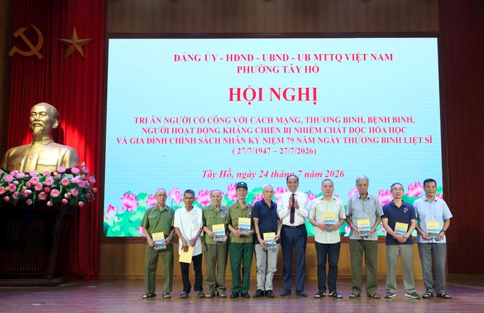 Bí thư Đảng ủy, Chủ tịch HĐND phường Tây Hồ trao tặng sổ tiết kiệm cho người có công với cách mạng và gia đình chính sách.