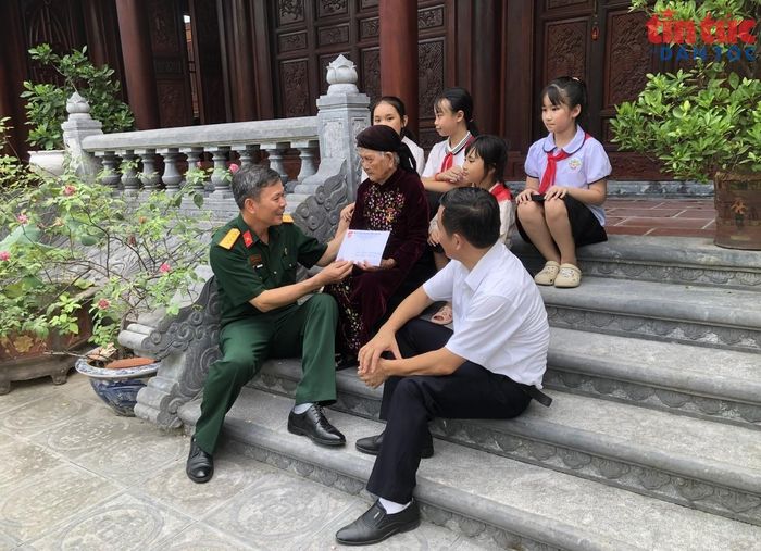 Đại tá Hoàng Văn Hanh, Chủ tịch Hội hỗ trợ gia đình liệt sĩ tỉnh Thanh Hóa (người mặc quân phục) tặng quà Mẹ Việt Nam Anh hùng Phan Thị Mùi năm nay đã 103 tuổi.