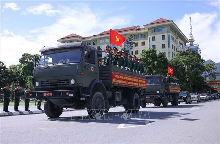 Đông đảo lực lượng vũ trang, nhân dân tỉnh Tuyên Quang đón đoàn xe chở hài cốt liệt sĩ di chuyển qua Quảng trường 26/3 phường Hà Giang 1. Ảnh: Hoàng Hiếu/TTXVN
