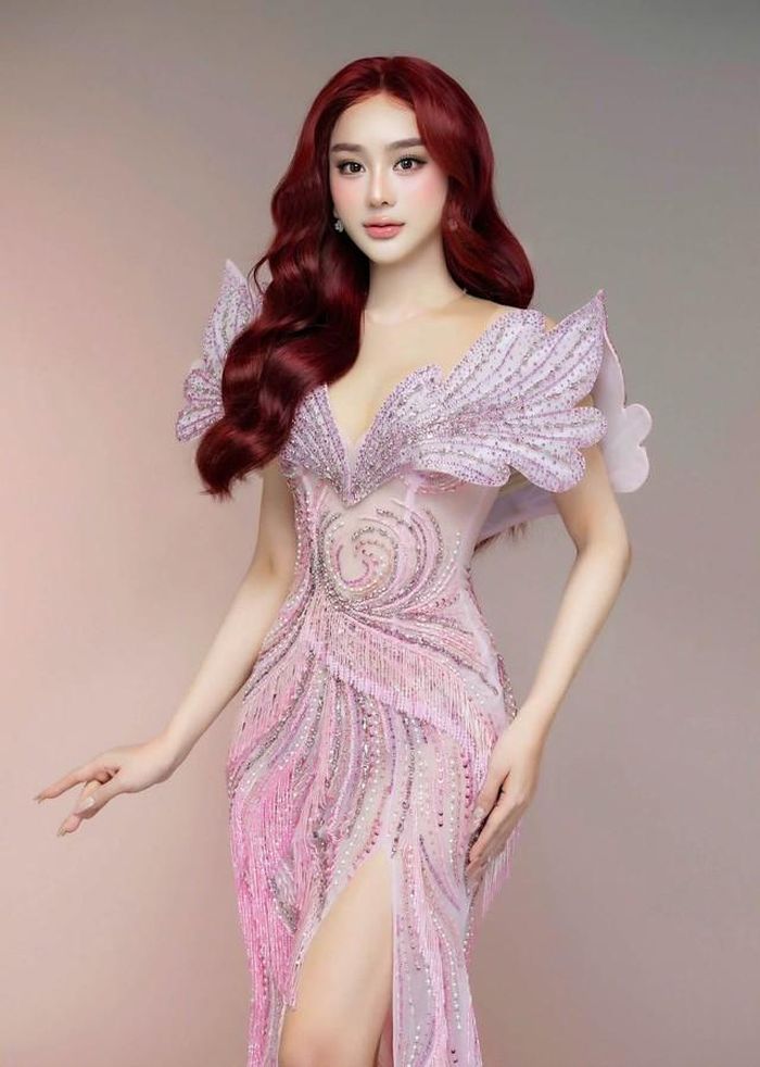 Nữ ca sĩ diện thiết kế đầm dạ hội màu hồng đính kết cầu kỳ, nổi bật với phần cổ khoét sâu cùng đường xẻ tà cao, khoe khéo vóc dáng thon gọn.