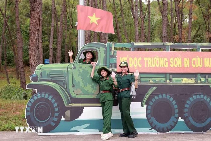 Du khách ghi lại những khoảnh khắc ý nghĩa bên các mô hình tái hiện tại Khu di tích lịch sử Quốc gia đặc biệt Ngã ba Đồng Lộc. (Ảnh: Hữu Quyết/TTXVN)