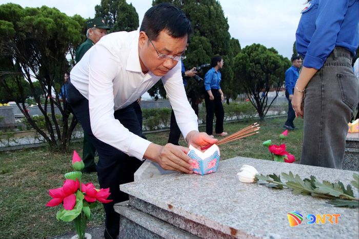 Bí thư Thành ủy Lê Ngọc Quang thắp nến tri ân lên mộ liệt sĩ. Ảnh: TRỌNG HUY