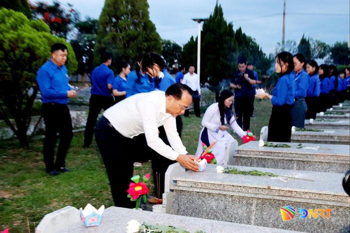 Phó Bí thư Thành ủy Nguyễn Đình Vĩnh thắp nến tri ân lên mộ liệt sĩ. Ảnh: TRỌNG HUY