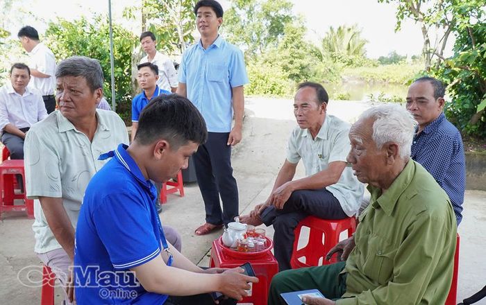 Cán bộ Xã Trần Phán tận tình hỗ trợ ông Đỗ Sơn Trạng, ấp Tân Hòa, cài đặt định danh điện tử VNeID.