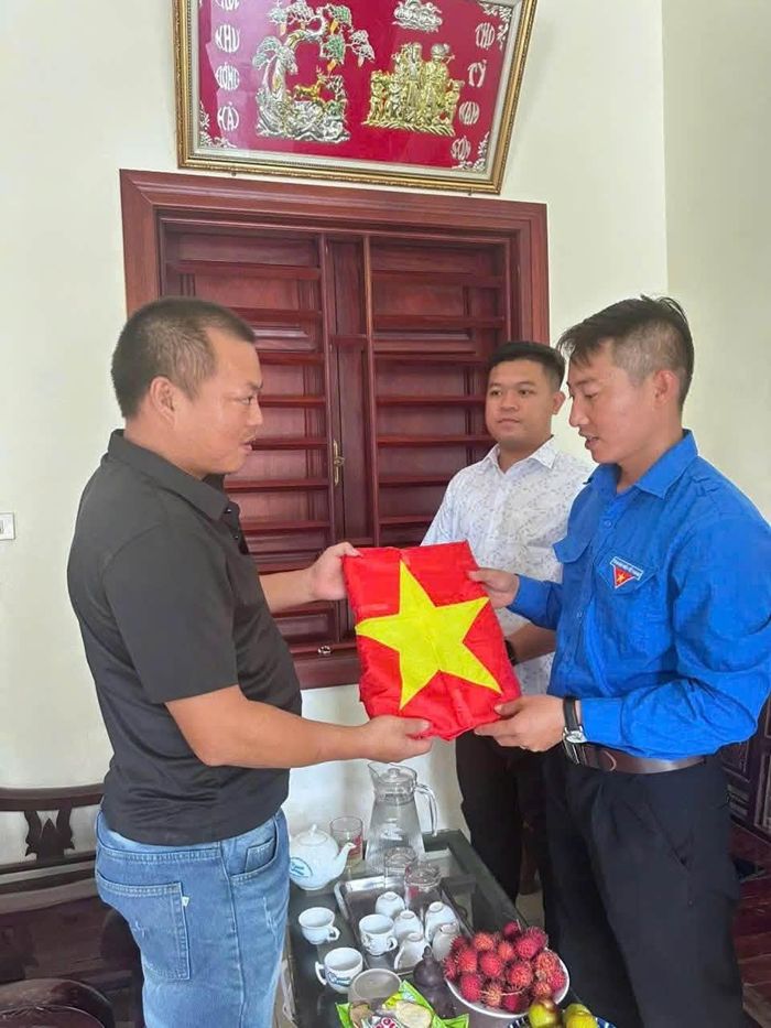 Thân nhân liệt sĩ trân trọng đón nhận các di ảnh được Đoàn TNCS Hồ Chí Minh xã Hồng Vân trao tặng. Ảnh: PV