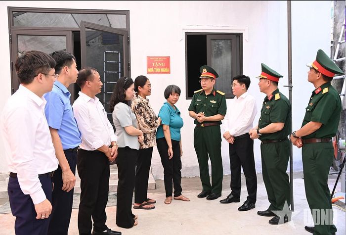 Các đại biểu chúc mừng gia đình bà Đỗ Thị Định tại buổi khánh thành, bàn giao nhà tình nghĩa. 