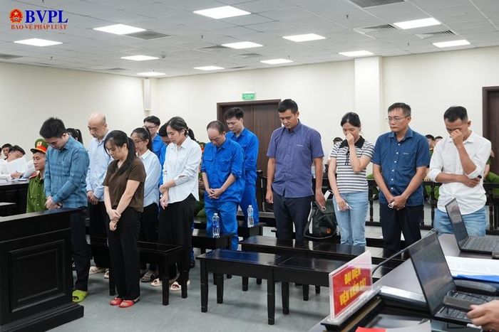 Các bị cáo đứng nghe đại diện Viện kiểm sát công bố bản cáo trạng truy tố bản thân.