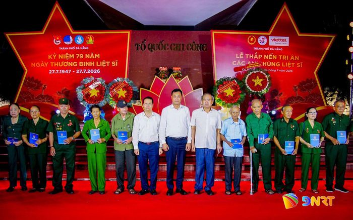Bí thư Thành ủy Lê Ngọc Quang (thứ 7, bên phải sang) và Chủ tịch UBND thành phố Nguyễn Mạnh Hùng (thứ 6, bên trái sang) tặng quà tri ân các cựu chiến binh, cựu thanh niên xung phong, thân nhân liệt sĩ tại buổi lễ. Ảnh: BẢO LÂM