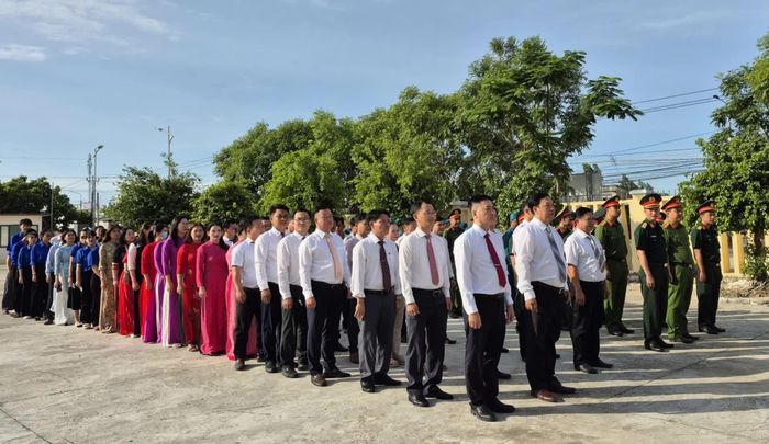 Các đại biểu thực hiện nghi thức chào cờ tại Nhà bia tưởng niệm liệt sĩ thôn Tân Lập.