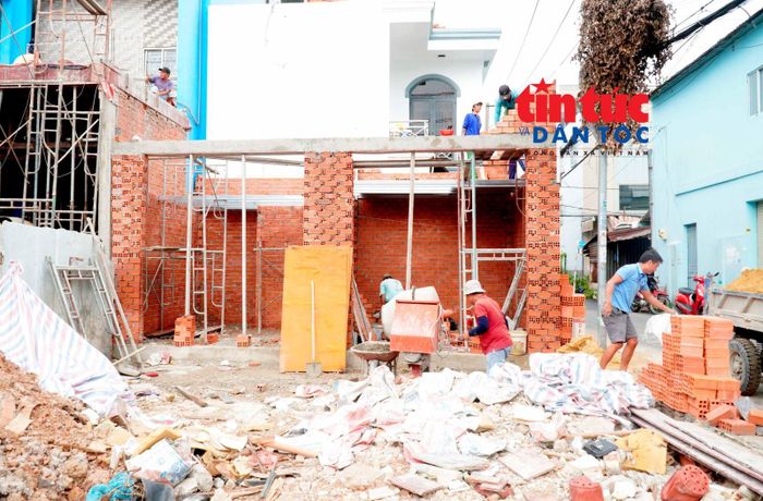 Người dân xây dựng lại nhà cửa trên phần ranh đất còn lại sau khi bàn giao mặt bằng phục vụ dự án mở rộng quốc lộ 22.