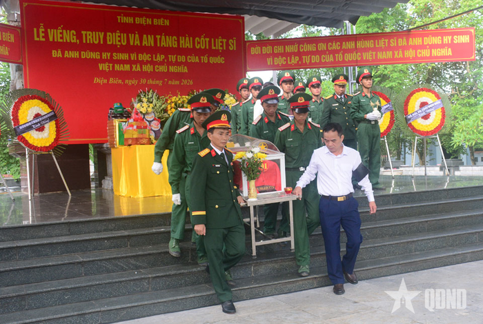 Thực hiện nghi lễ an táng hài cốt liệt sĩ.