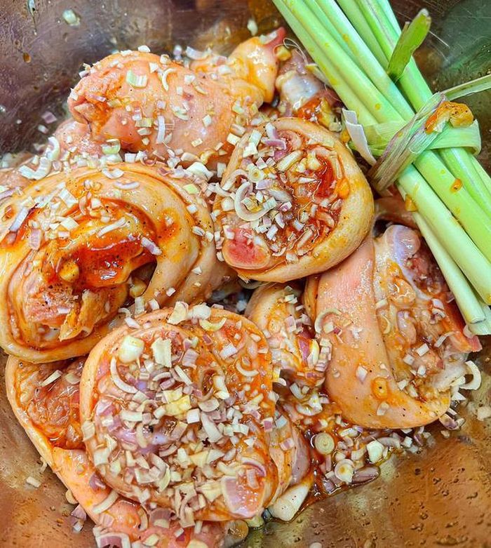 Băm nhỏ sả, ớt, tỏi, hành tím. Ướp chân giò với nước mắm, hạt nêm, dầu hào, tiêu, một ít nước màu, tương ớt cùng một lượng hành, tỏi, sả đã băm khoảng 30 phút cho ngấm gia vị. Ảnh: Đan Vy