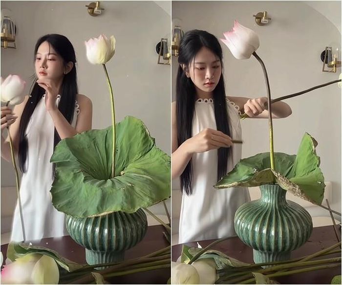 Sau khi hoàn thiện phần khung, Lê Bống lần lượt bổ sung các cành sen theo nguyên tắc xen kẽ cao thấp. Những bông ở tầng giữa được cô nhẹ nhàng lật bớt lớp cánh ngoài để nhụy vàng lộ rõ hơn, giúp tổng thể bình hoa trở nên mềm mại và có điểm nhấn.