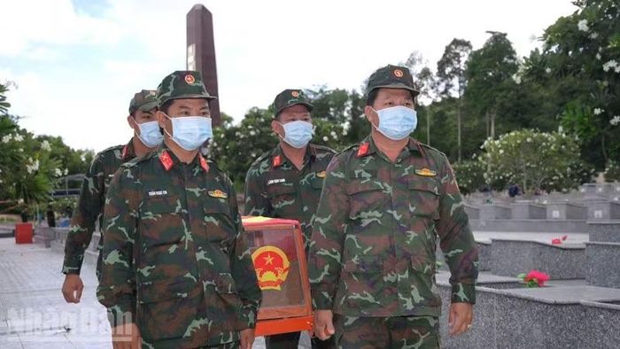 Đội lấy mẫu ADN hài cốt liệt sĩ tại Nghĩa trang Liệt sĩ Tri Tôn thực hiện nhiệm vụ. (Ảnh: PHƯƠNG VŨ)