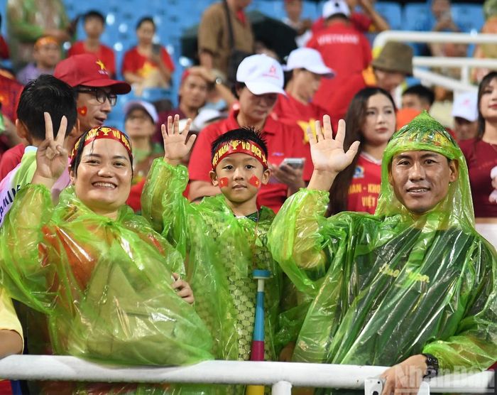 Một gia đình sẵn sàng khoác áo mưa, háo hức chờ đợi trận đấu của đội tuyển Việt Nam trên sân Mỹ Đình.