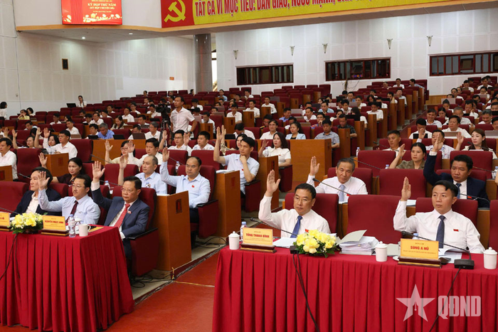 Đại biểu biểu quyết các nội dung tại kỳ họp. 