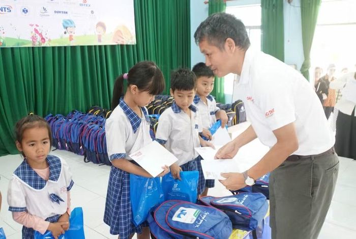Nhà báo Nguyễn Đức Tuân, Phó Tổng biên tập Báo Giáo dục và Thời đại trao quà và học bổng cho học sinh tiểu học.