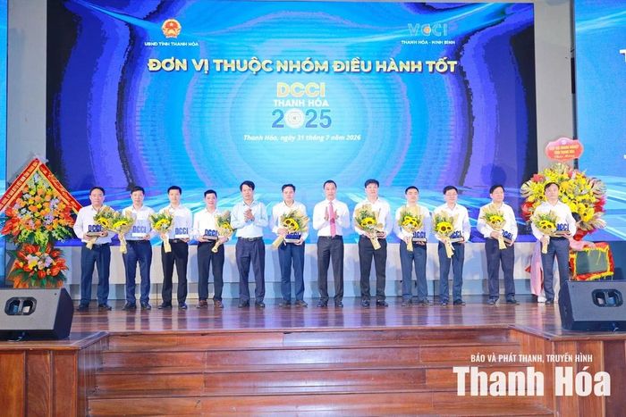 Chủ tịch UBND tỉnh Tô Anh Dũng và Trưởng Ban Tuyên giáo và Dân vận Tỉnh ủy Đào Xuân Yên trao biểu trưng và tặng hoa cho các các xã, phường thuộc nhóm tốt.
