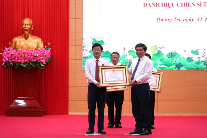 Thừa ủy quyền của Chủ tịch nước, đồng chí Trần Vũ Khiêm, Phó Bí thư Thường trực Tỉnh ủy, Trưởng đoàn đại biểu Quốc hội tỉnh trao Huân chương Lao động hạng Nhất cho đồng chí Ngô Quang Chiến, nguyên Giám đốc Sở Nội vụ tỉnh Quảng Trị (cũ) - Ảnh: T.Đ