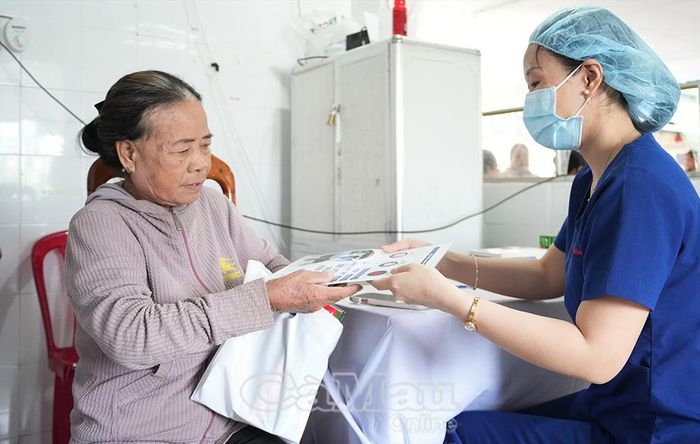 Bác sĩ tư vấn hướng dẫn theo dõi sức khỏe định kỳ cho bà Trần Kim Xuyến (Ấp 2, xã Năm Căn).